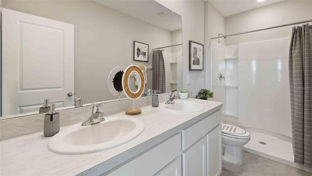 bathroom with a shower with shower curtain, tile patterned flooring, toilet, and vanity