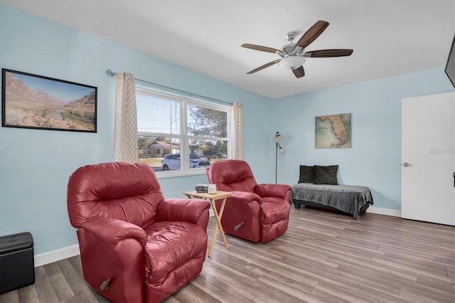 living room featuring hardwood / wood-style flooring and ceiling fan