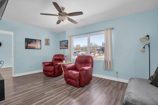 living room with ceiling fan and dark hardwood / wood-style floors