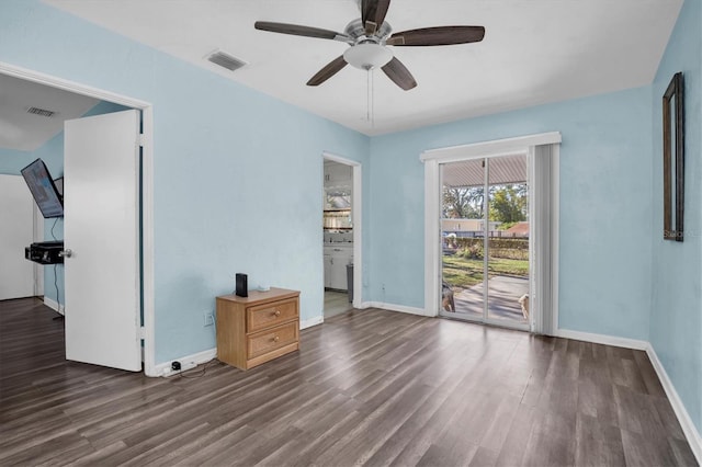 empty room with dark hardwood / wood-style flooring and ceiling fan