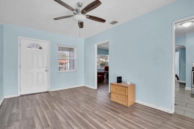 entrance foyer with ceiling fan and light hardwood / wood-style floors