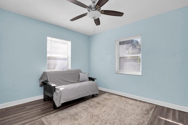 sitting room with hardwood / wood-style floors and ceiling fan