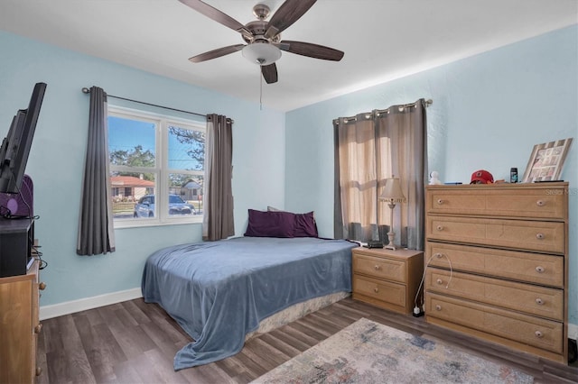 bedroom with ceiling fan and dark wood-type flooring