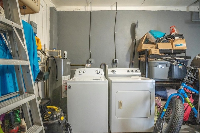 washroom with water heater and washer and dryer