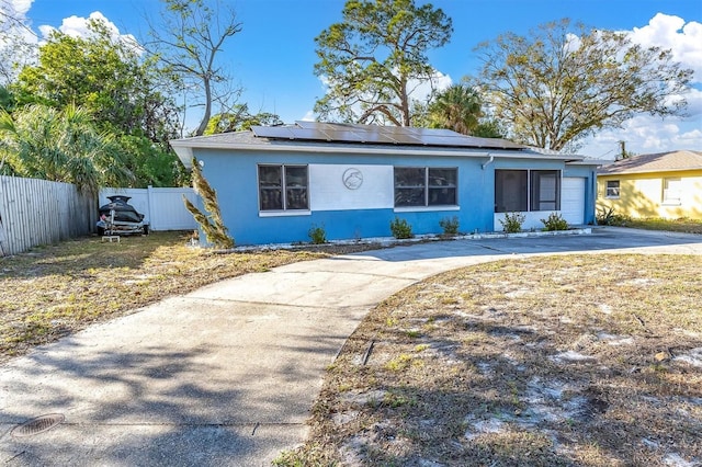 ranch-style house featuring solar panels