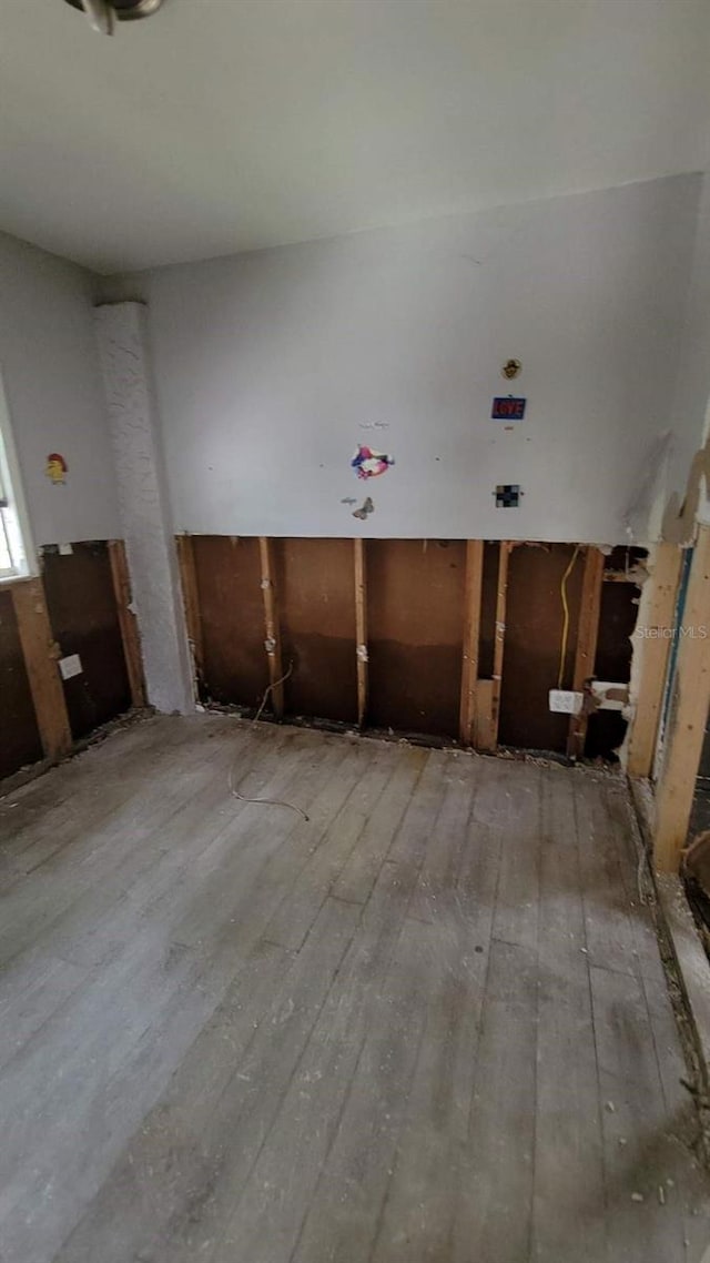 unfurnished room featuring hardwood / wood-style flooring