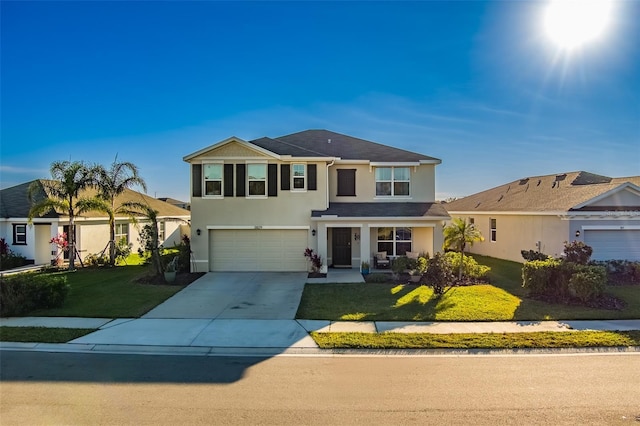 view of property with a front lawn and a garage