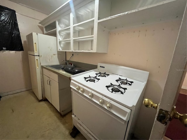 kitchen with white cabinetry, sink, and white gas stove