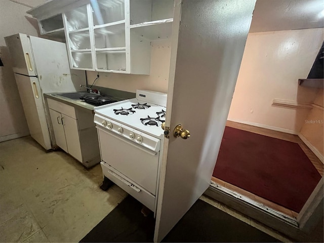 kitchen featuring white appliances, sink, and white cabinets