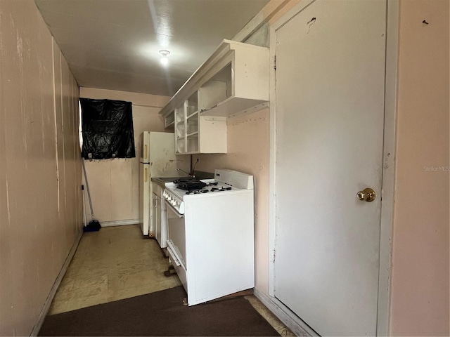 kitchen with white appliances and ventilation hood