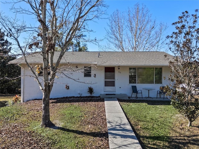 ranch-style house with a front lawn