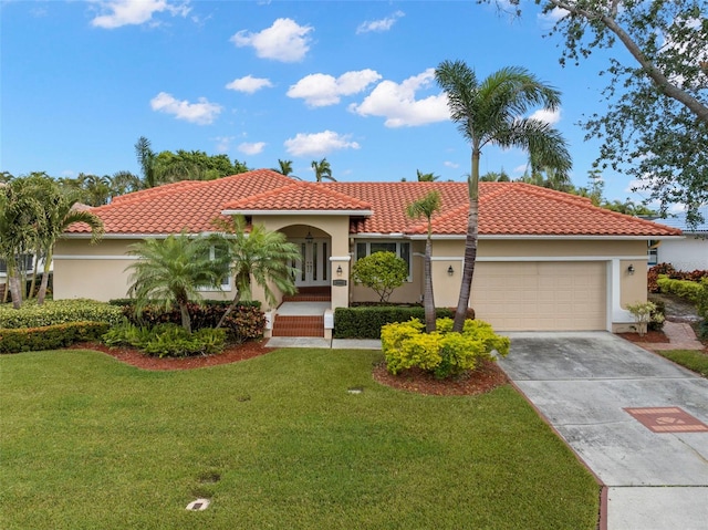 mediterranean / spanish-style home featuring a garage and a front lawn