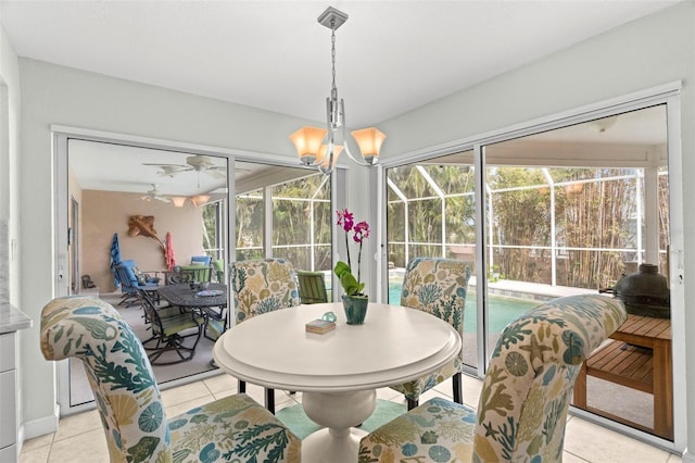 tiled dining space featuring plenty of natural light and ceiling fan