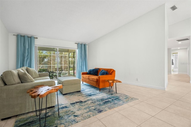 tiled living room featuring vaulted ceiling