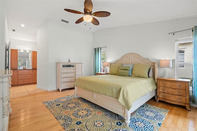 bedroom with ceiling fan, light hardwood / wood-style flooring, and vaulted ceiling