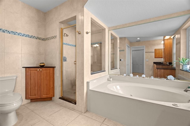 bathroom with plus walk in shower, tile patterned floors, toilet, tile walls, and a textured ceiling