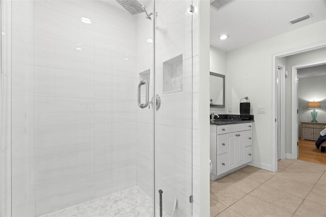 bathroom with tile patterned floors, vanity, toilet, and an enclosed shower