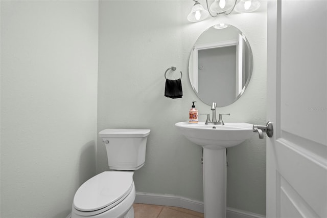 bathroom with toilet and tile patterned floors