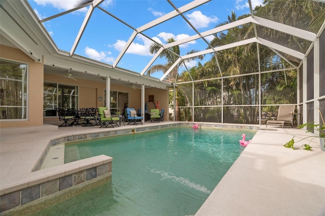 view of pool featuring a patio area, ceiling fan, and glass enclosure