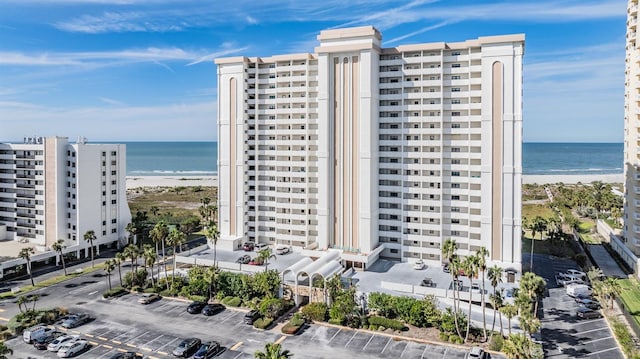 view of property with a beach view and a water view