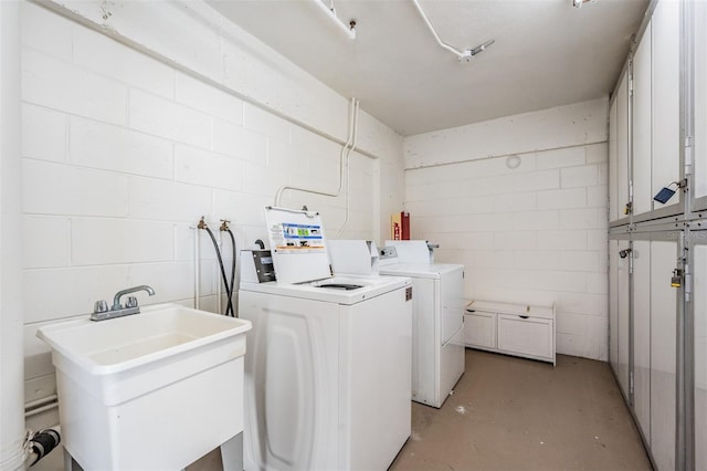 washroom featuring cabinets, separate washer and dryer, and sink