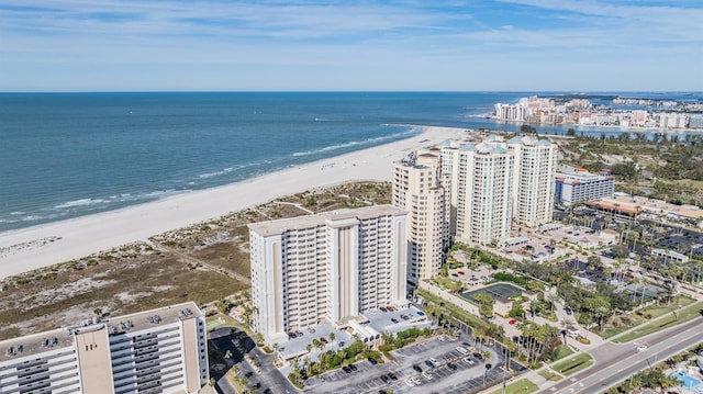 bird's eye view with a water view and a beach view