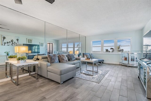 1230 Gulf Blvd Unit 604, Clearwater Beach, FL 33767 - living room featuring wood finished floors, a textured ceiling, and baseboards