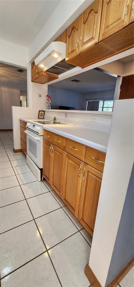 kitchen with light tile patterned floors and electric range