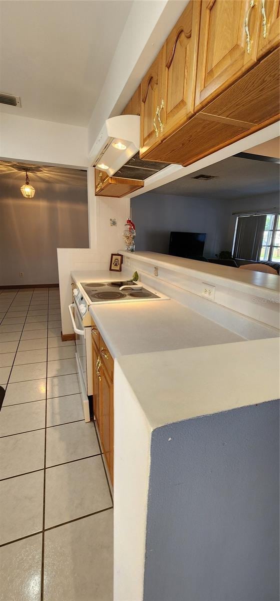 kitchen with exhaust hood, white range with electric stovetop, and light tile patterned flooring