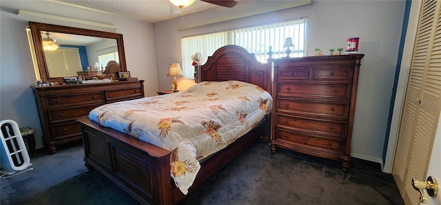 carpeted bedroom with ceiling fan, a textured ceiling, and a closet