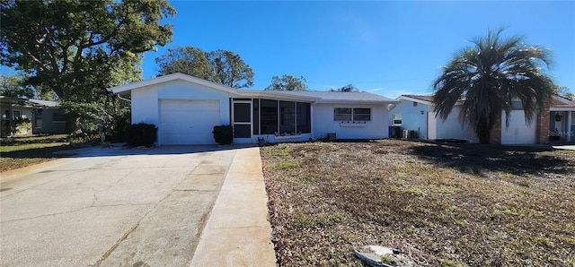 ranch-style house with a garage, central air condition unit, and a front yard