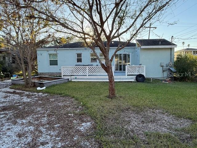 rear view of house with a yard