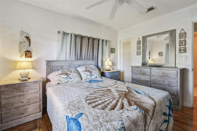 bedroom with dark hardwood / wood-style floors and ceiling fan