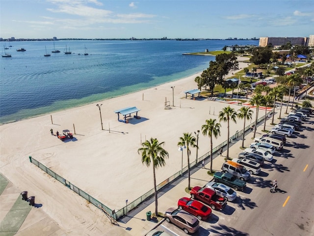 birds eye view of property with a water view and a beach view