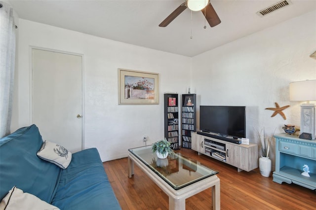 living room featuring ceiling fan and wood-type flooring