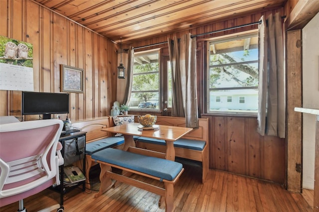 interior space with wooden walls, light hardwood / wood-style flooring, and wood ceiling