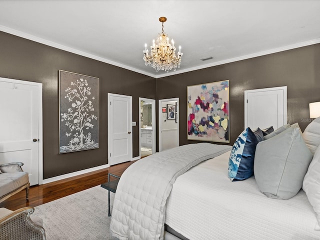 bedroom with hardwood / wood-style flooring, ornamental molding, connected bathroom, and a chandelier