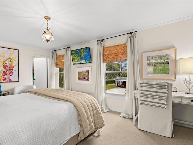 carpeted bedroom featuring a chandelier