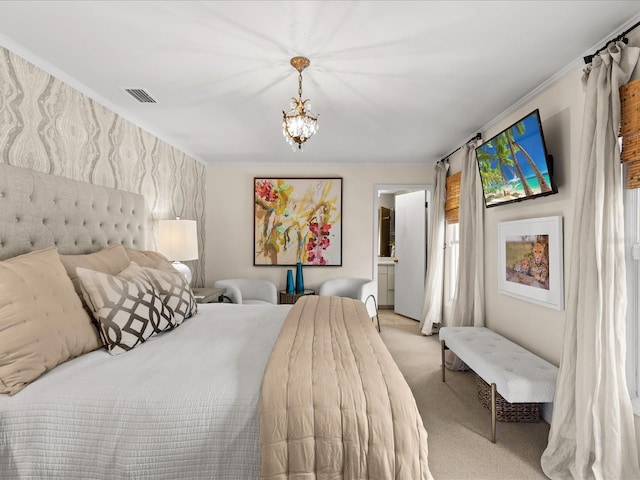 carpeted bedroom featuring ensuite bathroom and an inviting chandelier