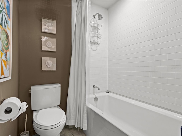 bathroom featuring shower / tub combo and toilet