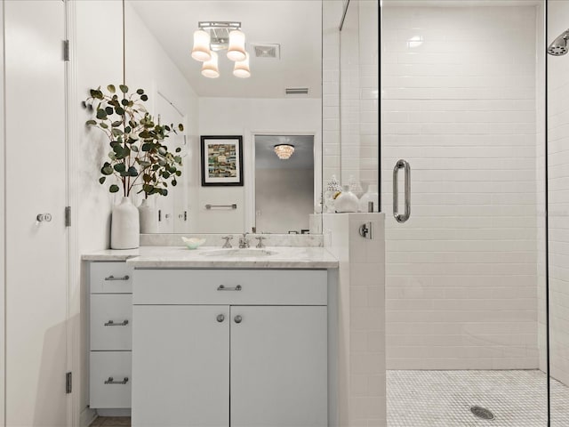 bathroom featuring vanity and an enclosed shower