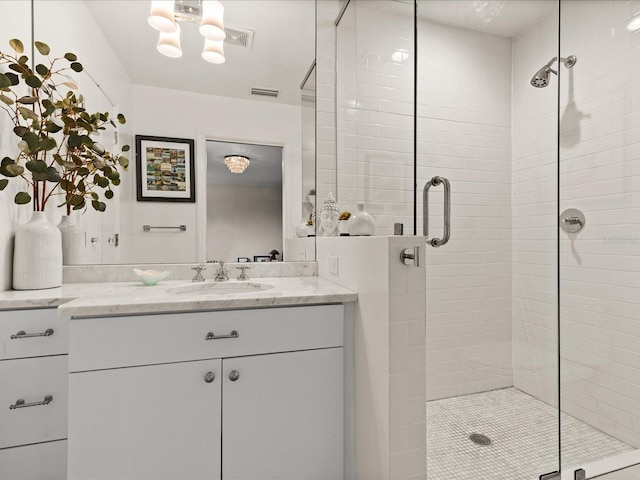 bathroom with vanity and a shower with shower door