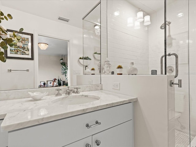 bathroom featuring vanity and a shower with shower door