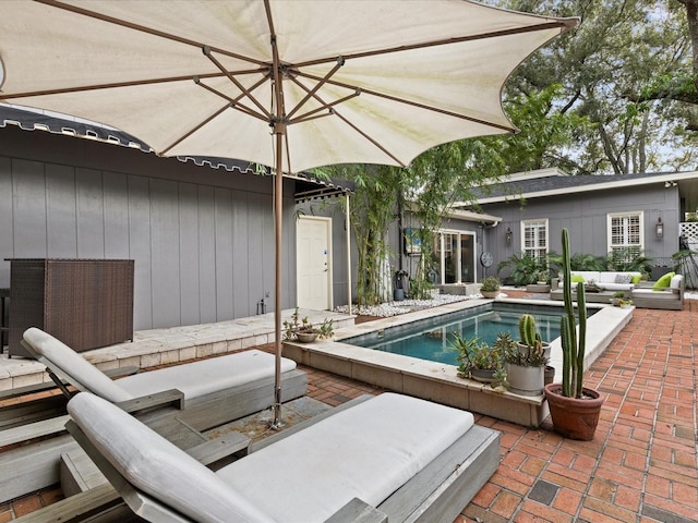 view of swimming pool with outdoor lounge area and a patio