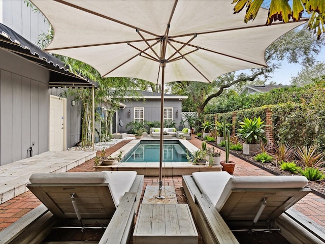 view of swimming pool featuring an outbuilding and a patio area