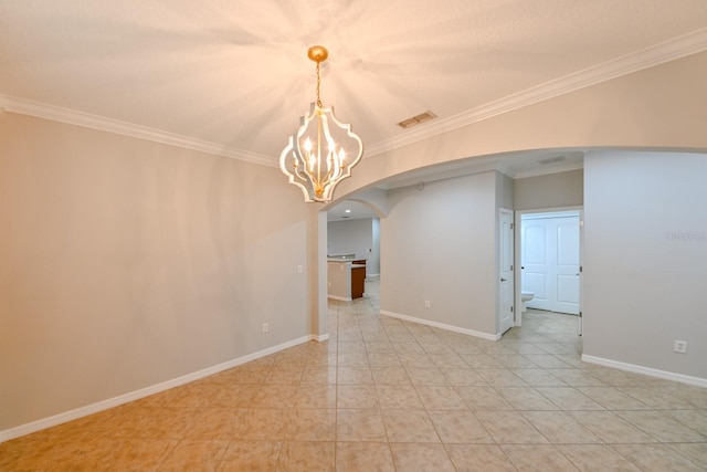 spare room featuring crown molding and a notable chandelier