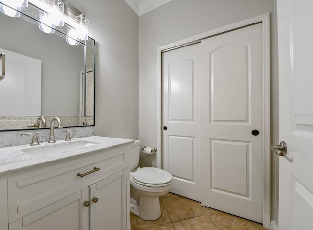 bathroom with ornamental molding, tile patterned flooring, vanity, and toilet