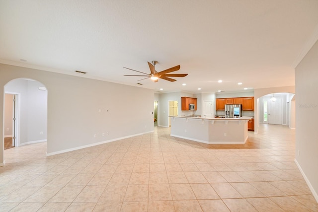 unfurnished living room with light tile patterned flooring, ceiling fan, and crown molding