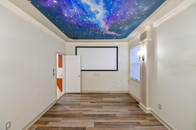 home theater featuring ornamental molding and hardwood / wood-style flooring