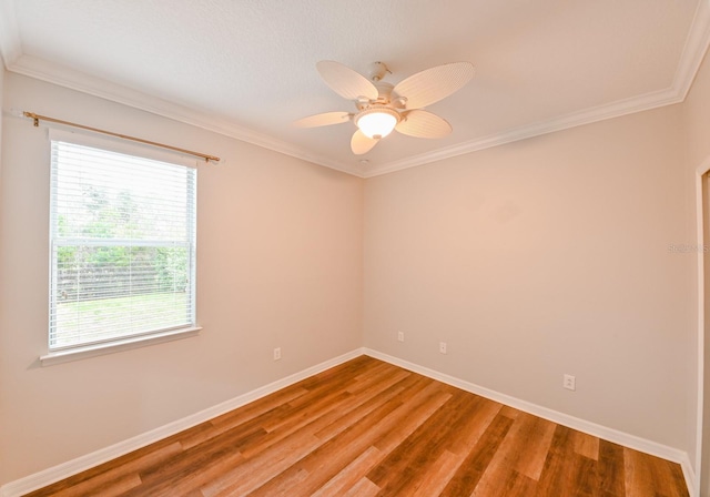 unfurnished room featuring ceiling fan, crown molding, hardwood / wood-style floors, and a wealth of natural light